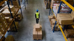 Man in warehouse with a trailer full of boxes